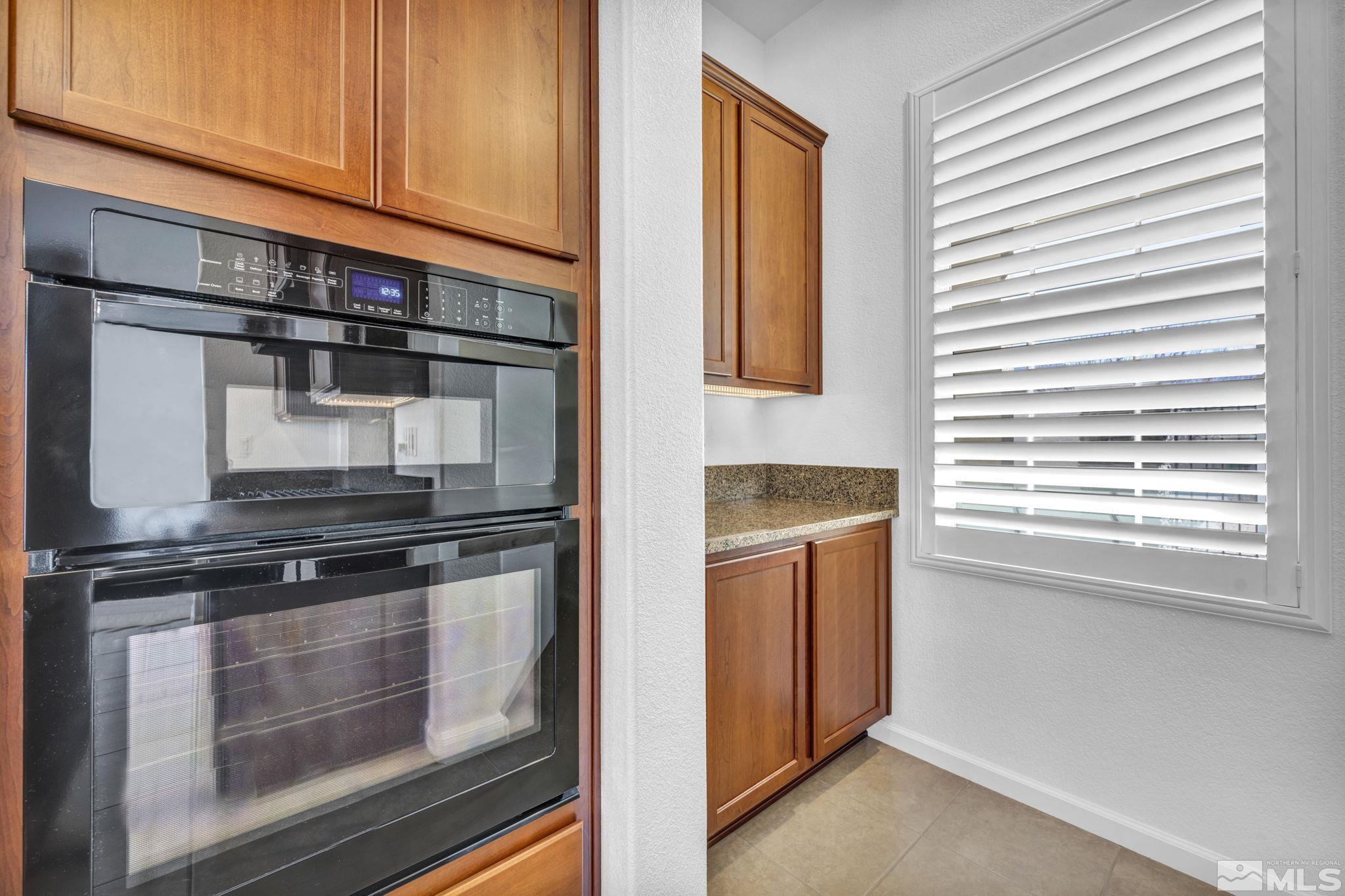 9825 Hafflinger Lane Reno, NV 89521 - Photo 11 of 39 a kitchen with stainless steel appliances granite countertop a stove and a refrigerator