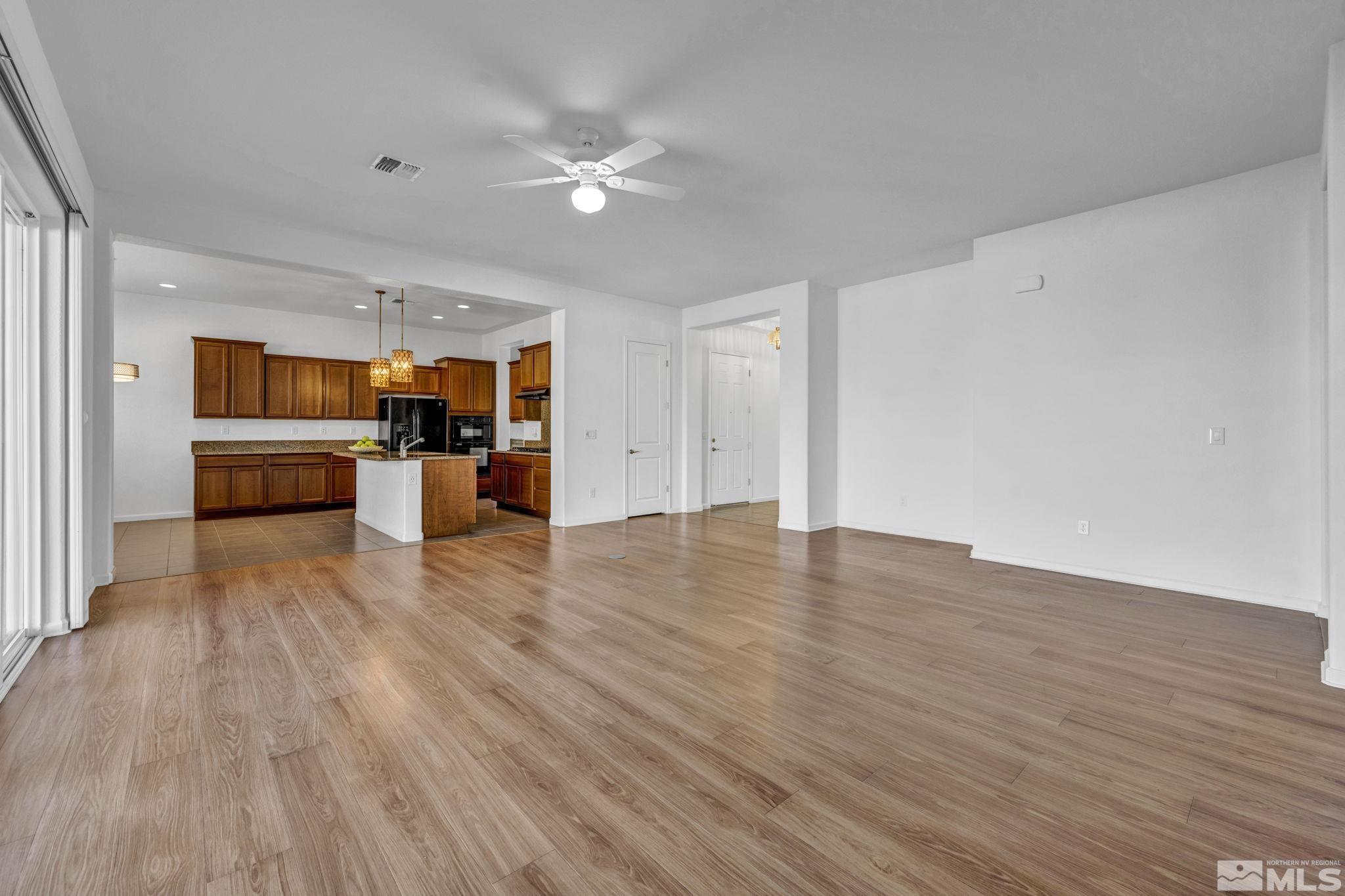 9825 Hafflinger Lane Reno, NV 89521 - Photo 13 of 39 a view of empty room with kitchen and window