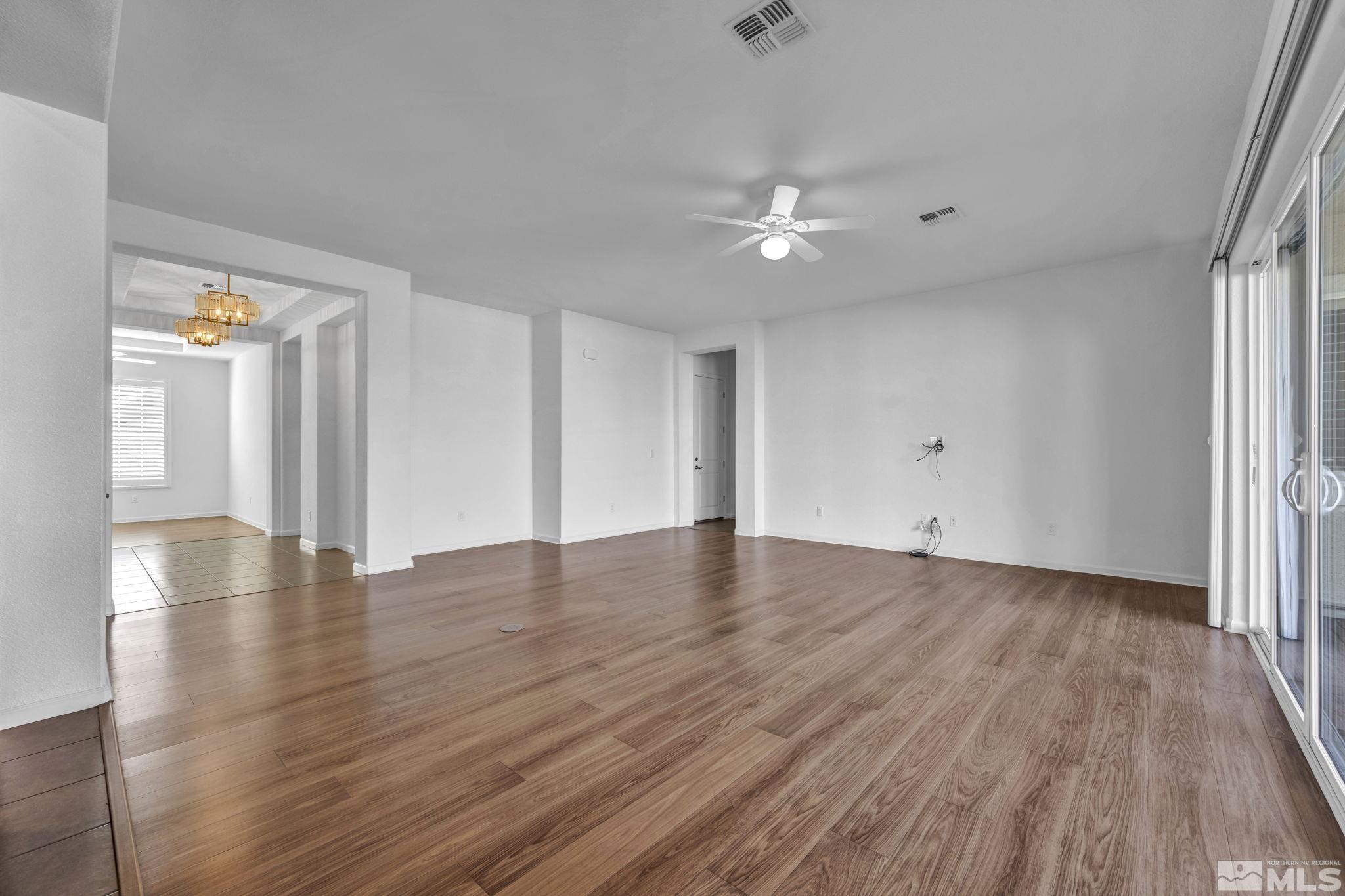 9825 Hafflinger Lane Reno, NV 89521 - Photo 15 of 39 wooden floor in an empty room with a window