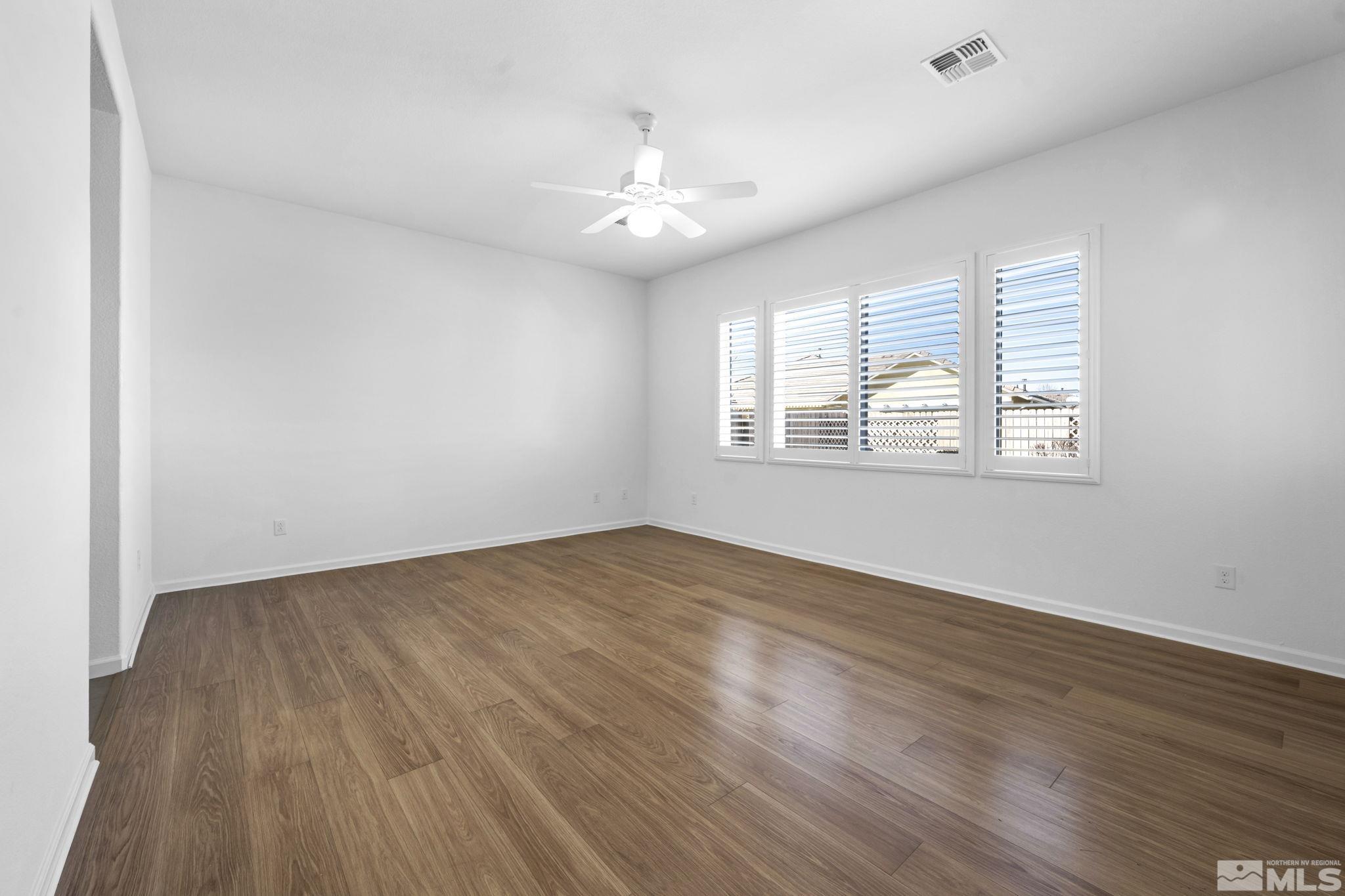 9825 Hafflinger Lane Reno, NV 89521 - Photo 16 of 39 wooden floor in an empty room with a window