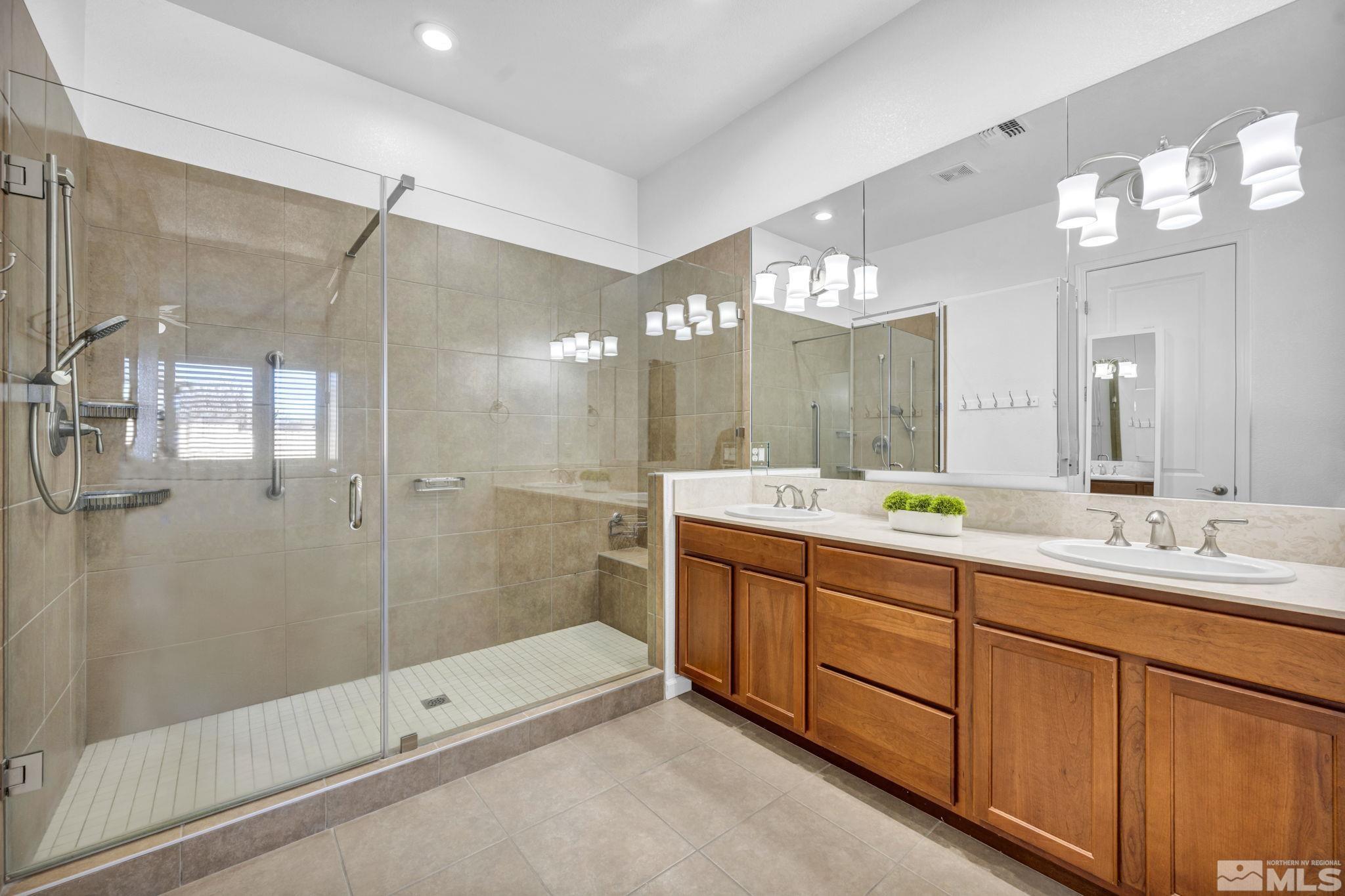 9825 Hafflinger Lane Reno, NV 89521 - Photo 19 of 39 a bathroom with a double vanity sink mirror and shower