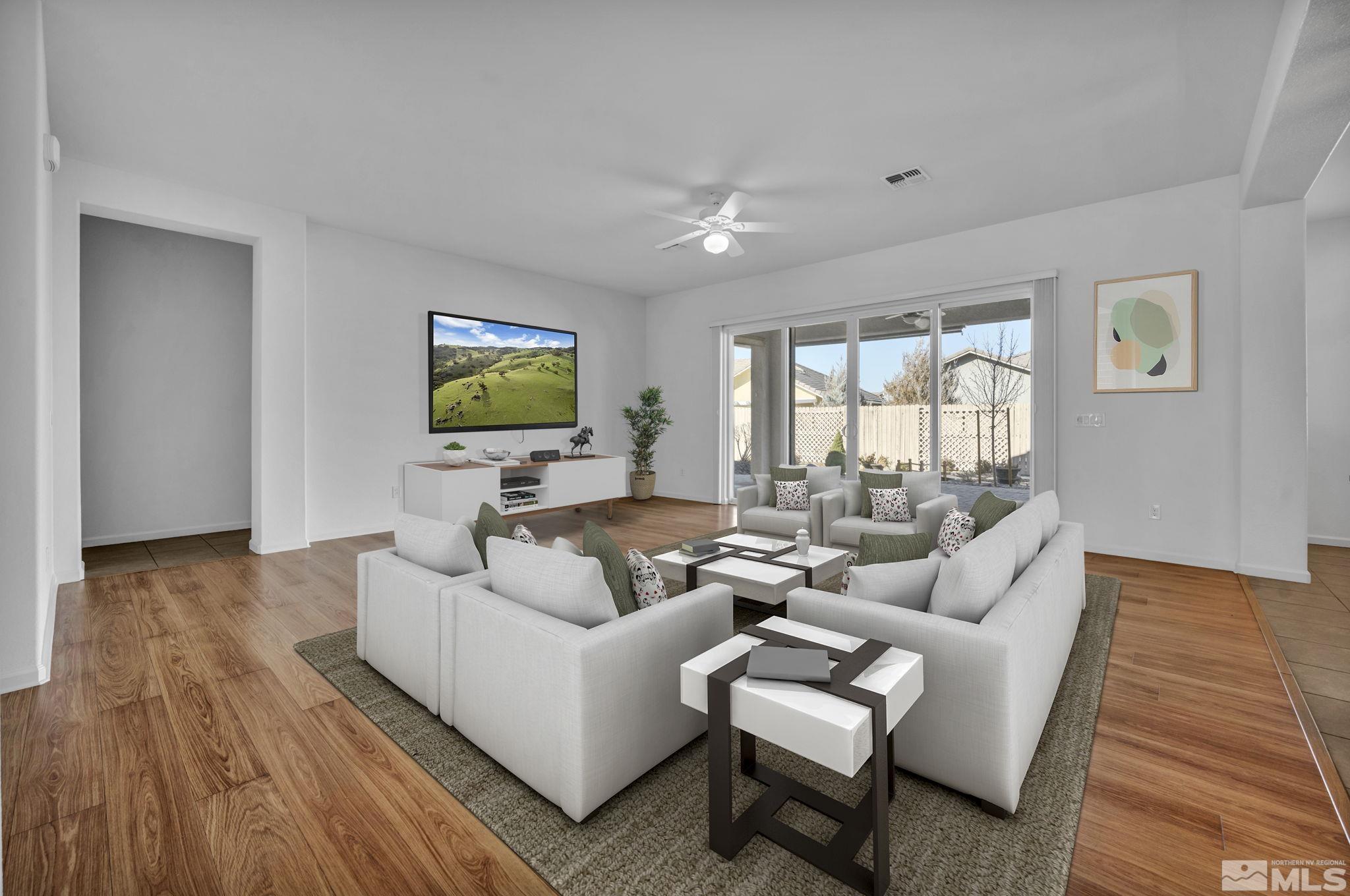 9825 Hafflinger Lane Reno, NV 89521 - Photo 2 of 39 a living room with furniture wooden floor and a flat screen tv