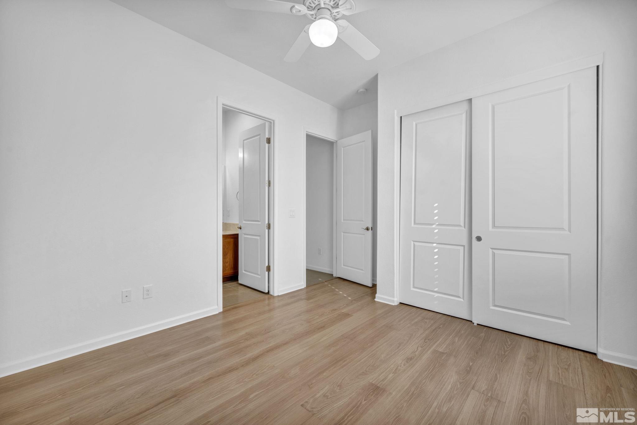 9825 Hafflinger Lane Reno, NV 89521 - Photo 22 of 39 a view of an empty room with wooden floor