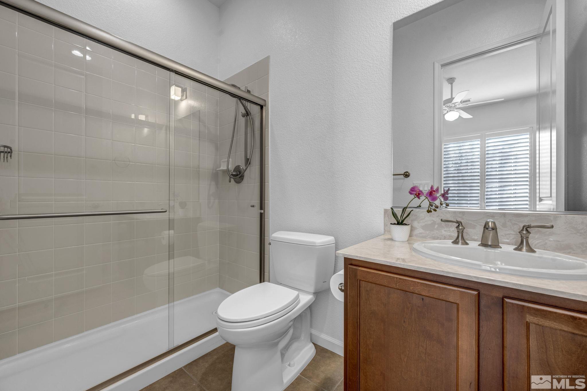 9825 Hafflinger Lane Reno, NV 89521 - Photo 23 of 39 a bathroom with a sink toilet and shower