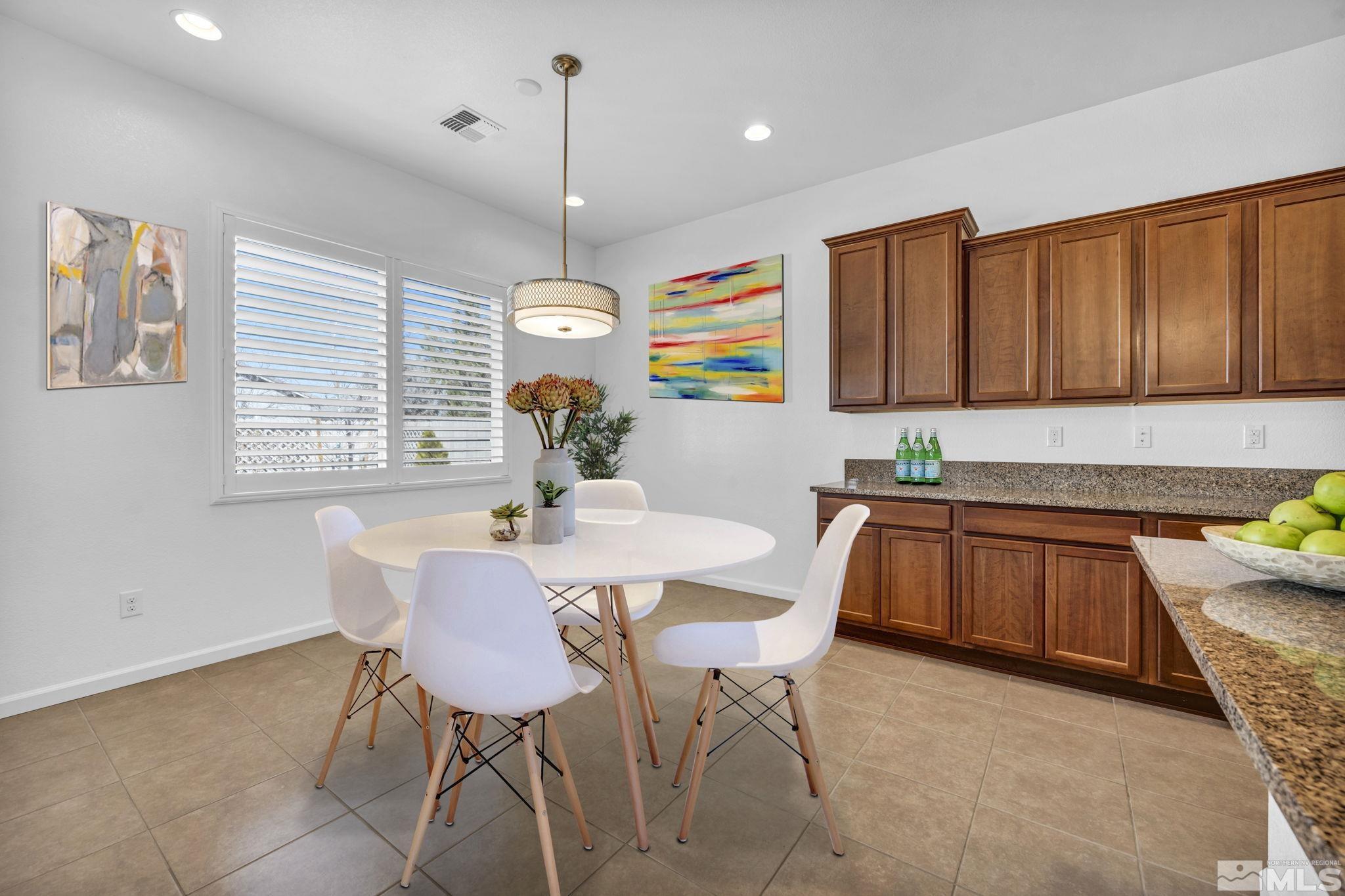 9825 Hafflinger Lane Reno, NV 89521 - Photo 3 of 39 a large kitchen with a table and chairs