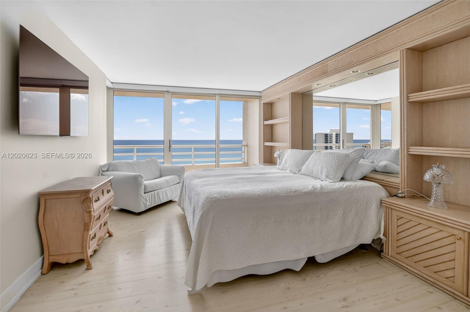 4101 North Ocean Boulevard, Unit 1605 Boca Raton, FL 33431 - Photo 21 of 35 a bedroom with a bed couch and a window