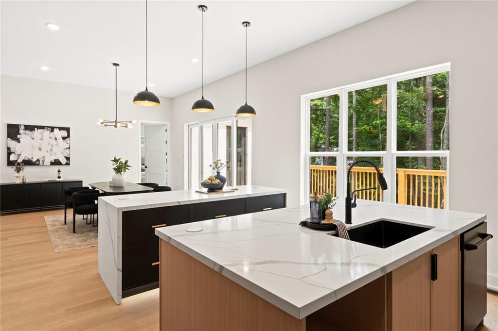7066 Bells Way Fairburn, GA 30213 - Photo 26 of 64 a kitchen with a stove a sink a counter and chairs