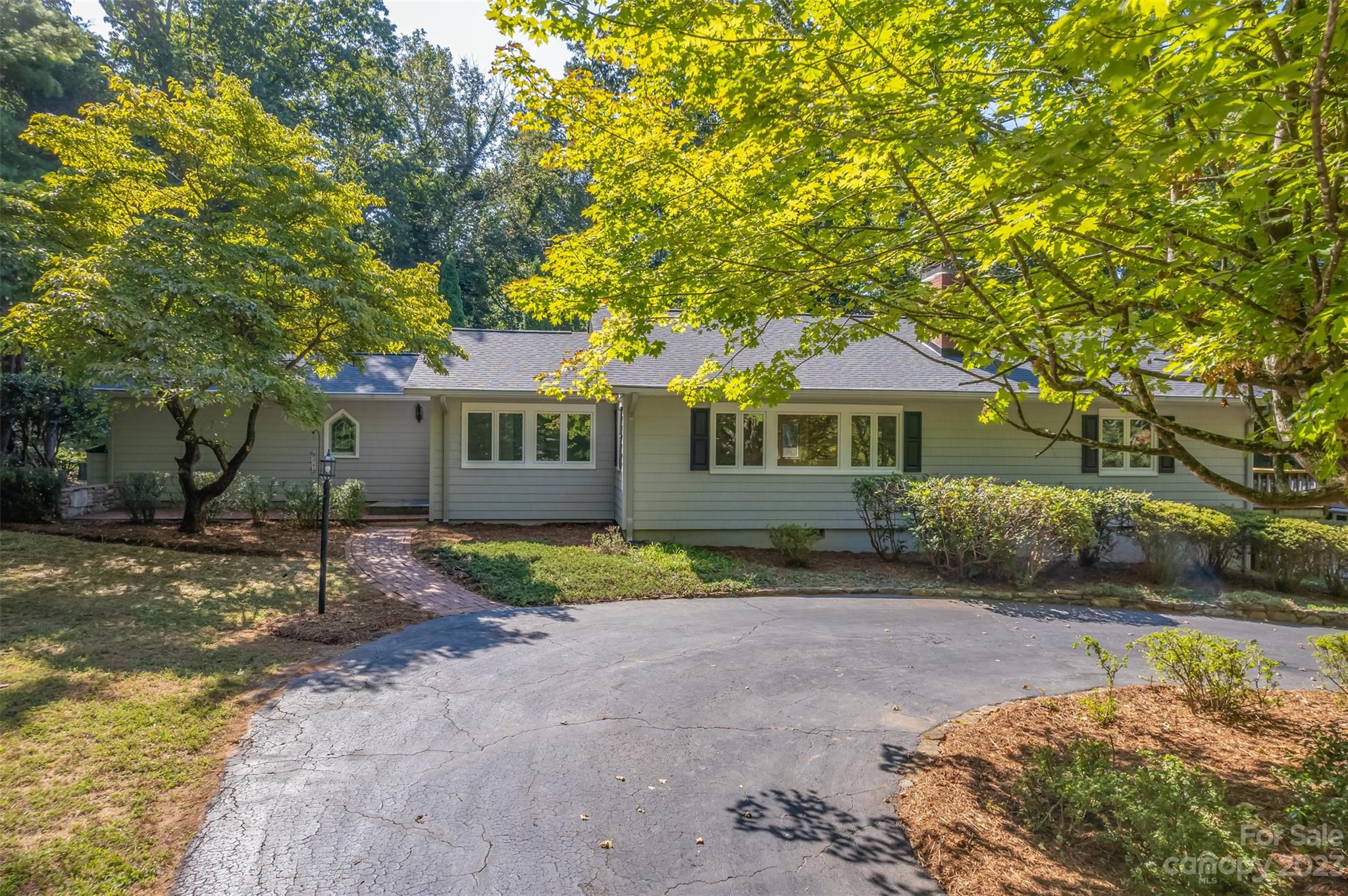 269 Golden Road Tryon, NC 28782 - Photo 4 of 43 a front view of a house with a garden