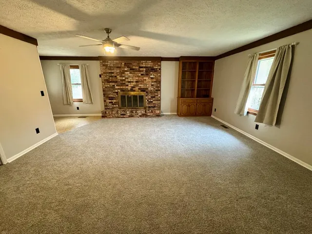 a bathroom with a granite countertop toilet sink and mirror