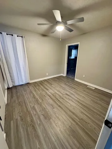 a utility room with a refrigerator and a window