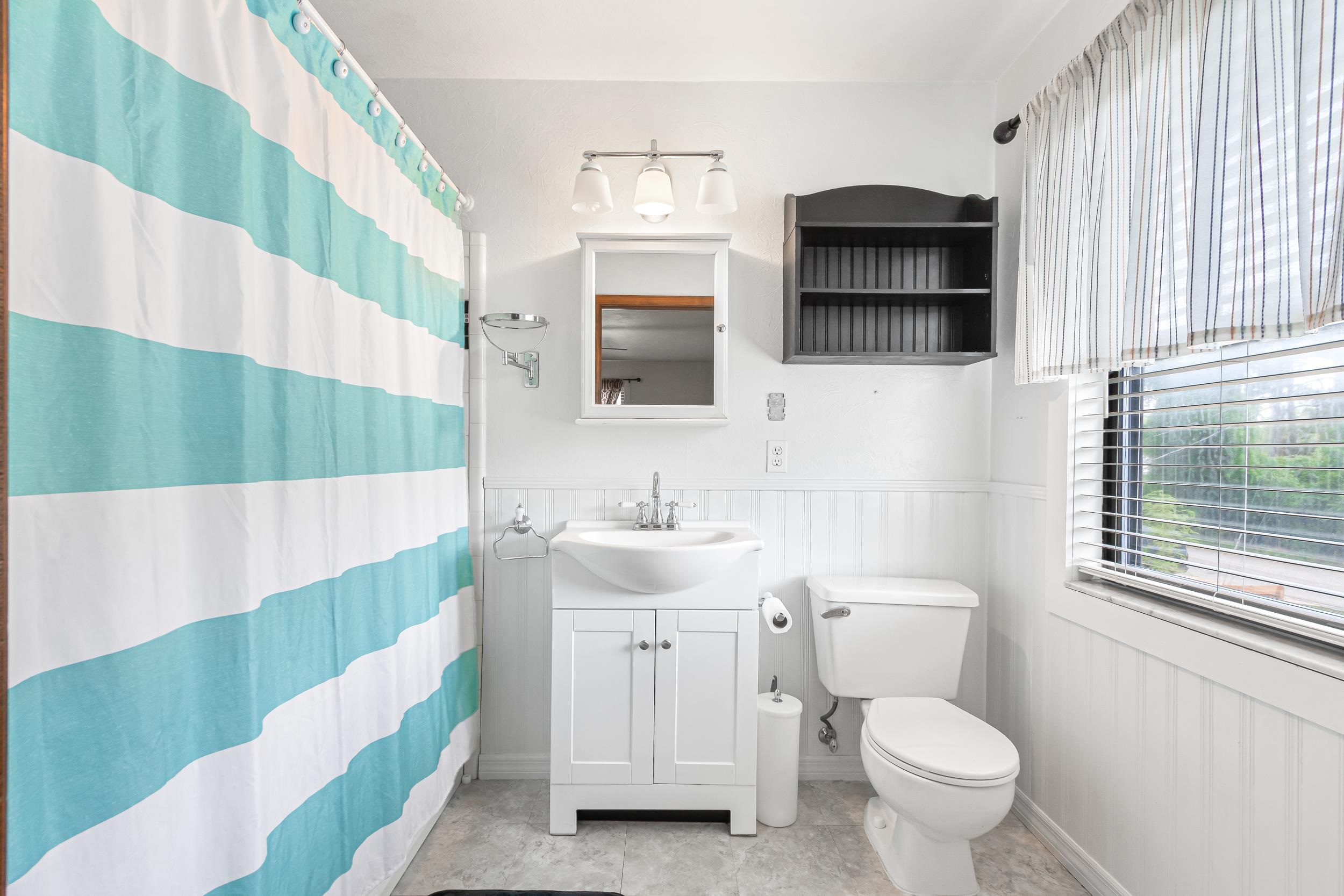 110 Harvard Road St. Augustine, FL 32086 - Photo 21 of 42 a bathroom with a sink toilet a mirror and shower