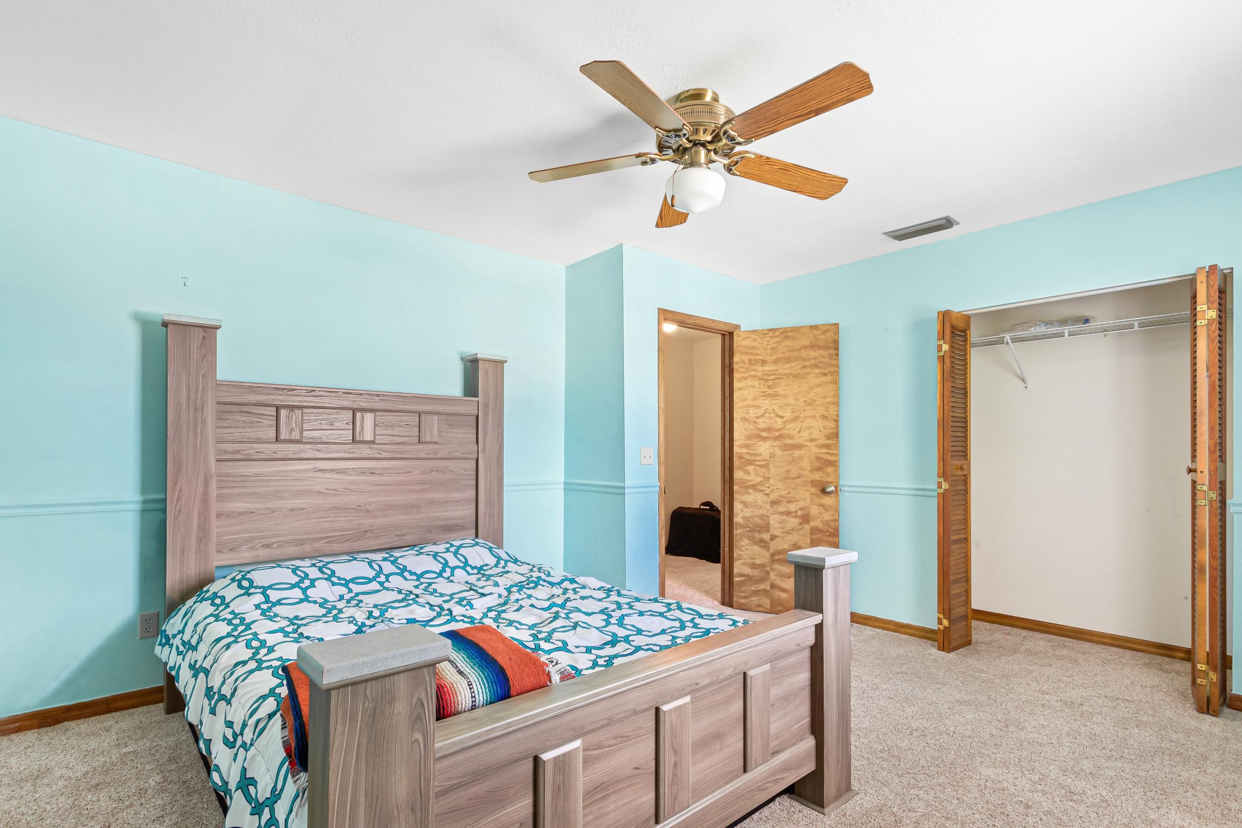 110 Harvard Road St. Augustine, FL 32086 - Photo 23 of 42 a bedroom with a bed and a chandelier