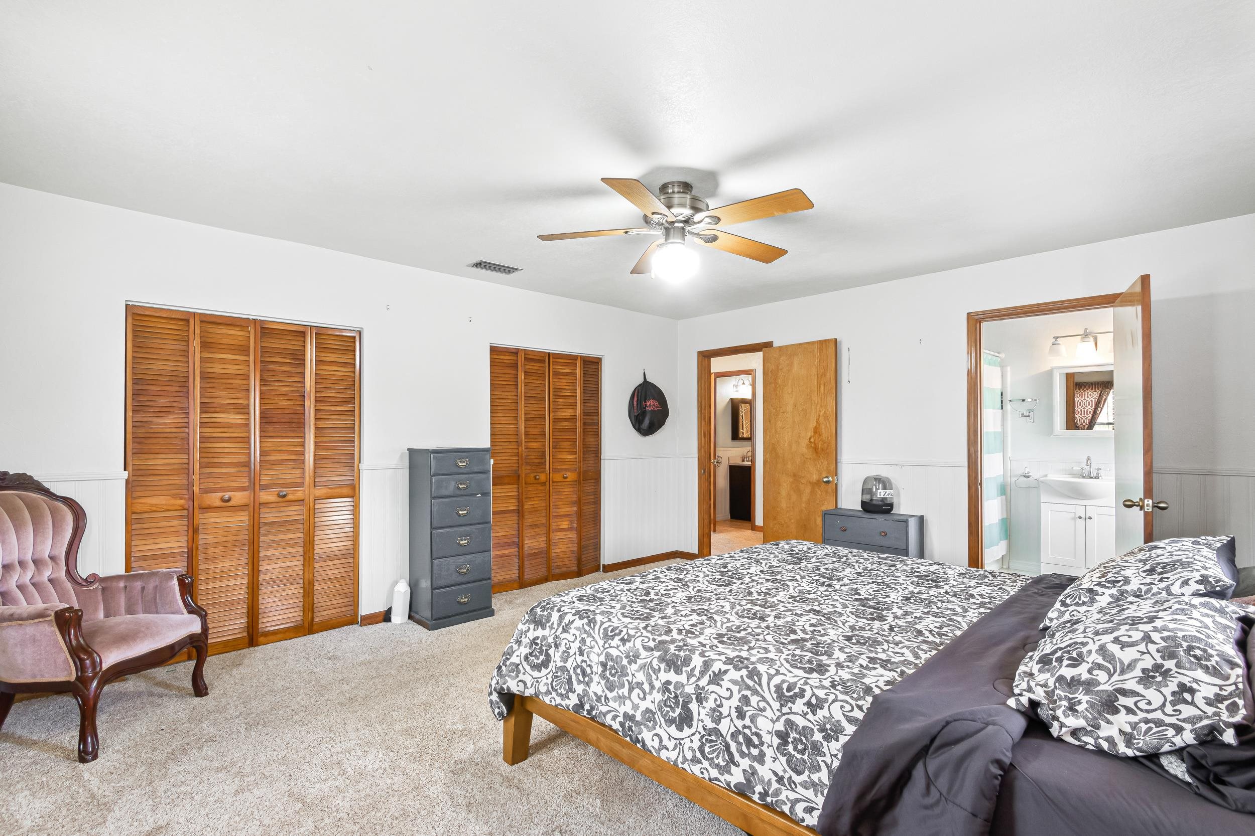 110 Harvard Road St. Augustine, FL 32086 - Photo 28 of 42 a bedroom with a large bed and a chandelier