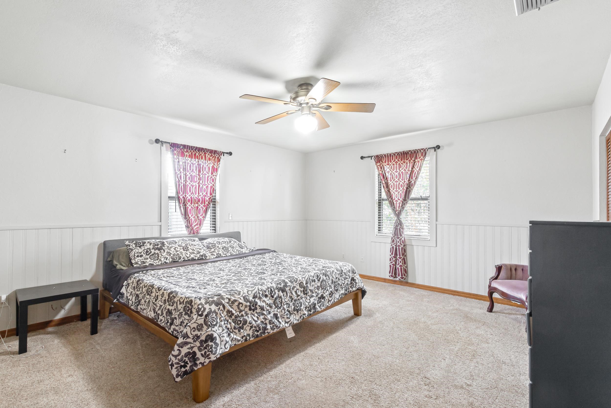 110 Harvard Road St. Augustine, FL 32086 - Photo 30 of 42 a bedroom with a bed and a chandelier