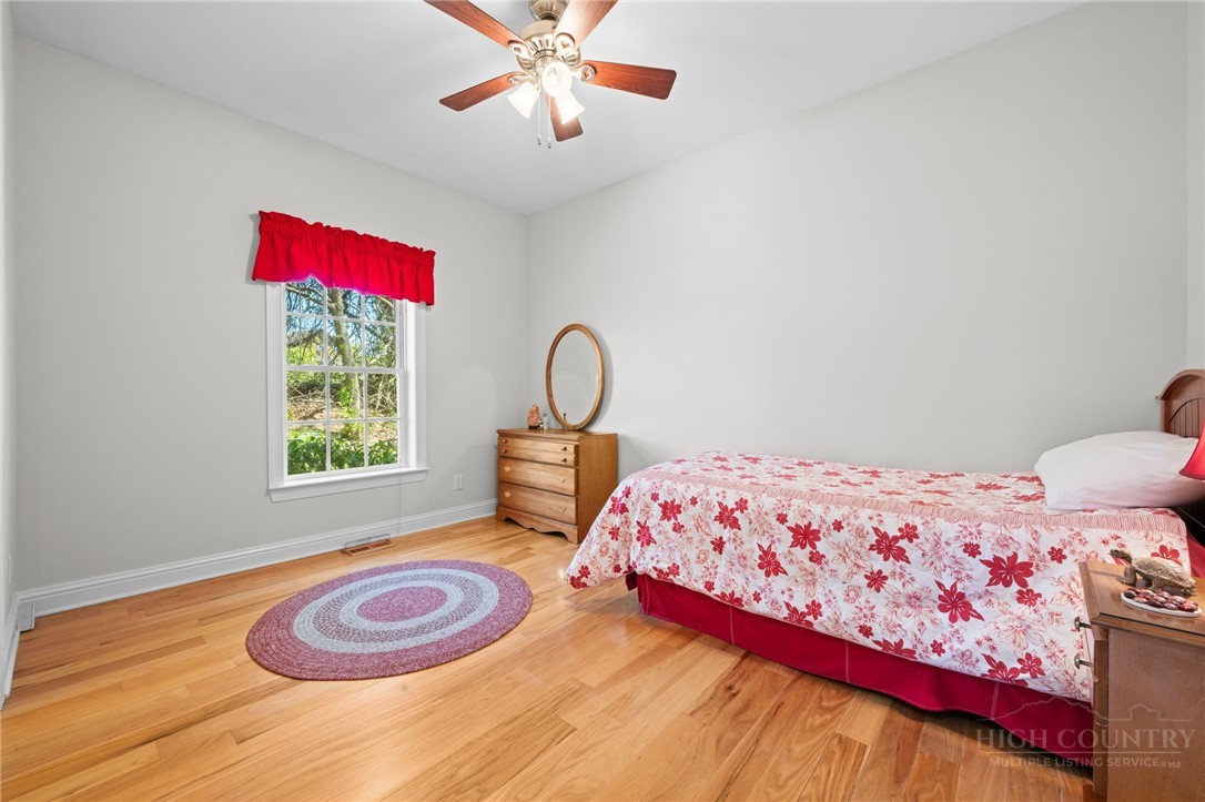 982 Brown's Chapel Road Boone, NC 28607 - Photo 17 of 42 a bedroom with a bed and a window