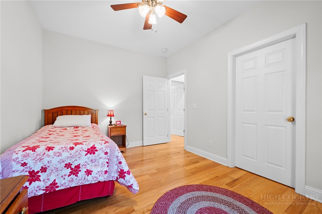 982 Brown's Chapel Road Boone, NC 28607 - Photo 18 of 42 a bedroom with a bed and a chandelier