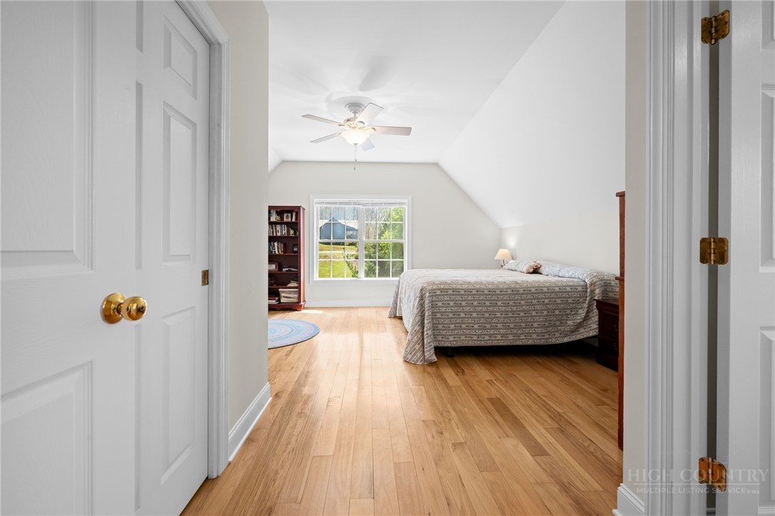 982 Brown's Chapel Road Boone, NC 28607 - Photo 22 of 42 a bedroom with a bed and wooden floor