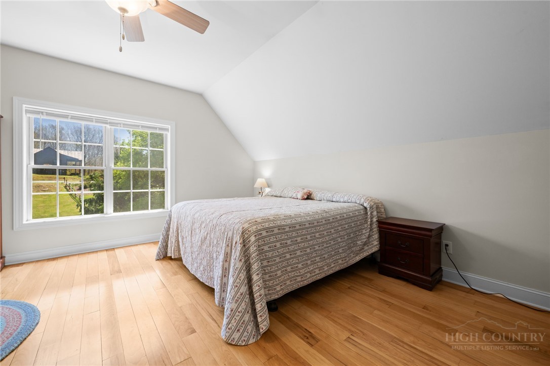 982 Brown's Chapel Road Boone, NC 28607 - Photo 23 of 42 a bedroom with a bed and a window