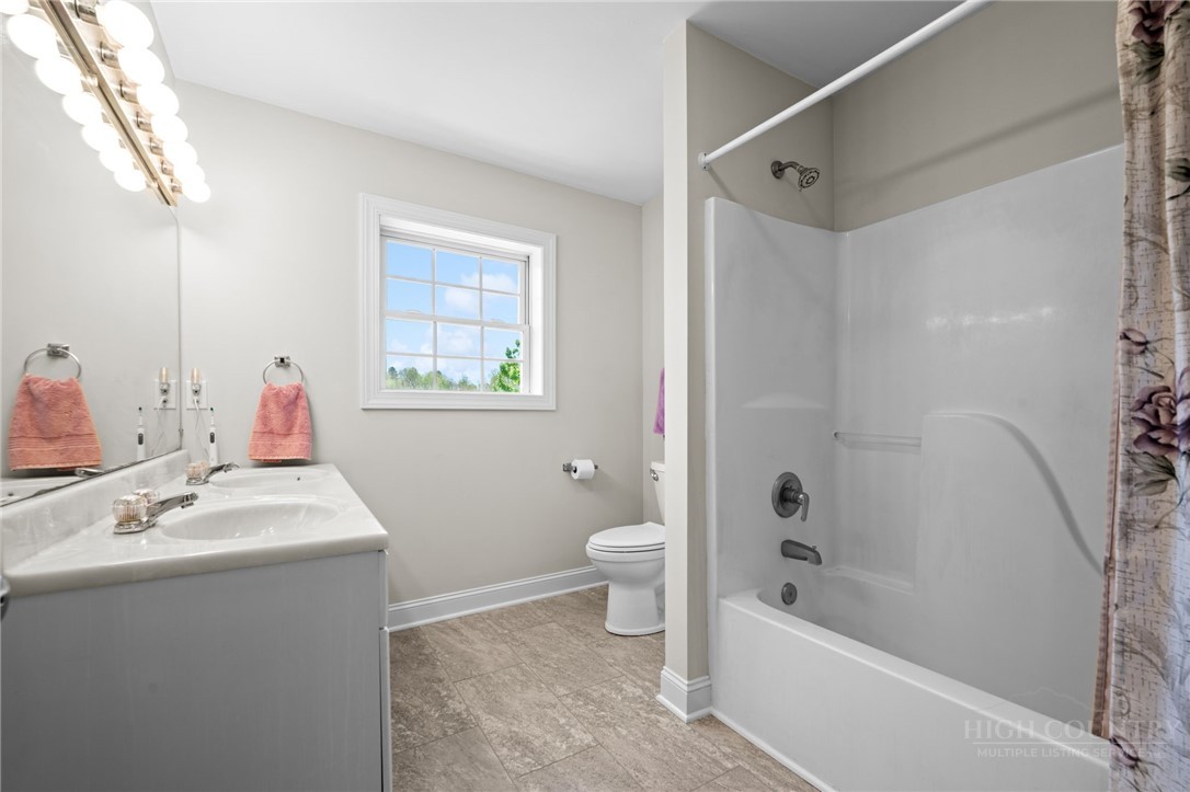 982 Brown's Chapel Road Boone, NC 28607 - Photo 25 of 42 a bathroom with a sink mirror toilet and bathtub