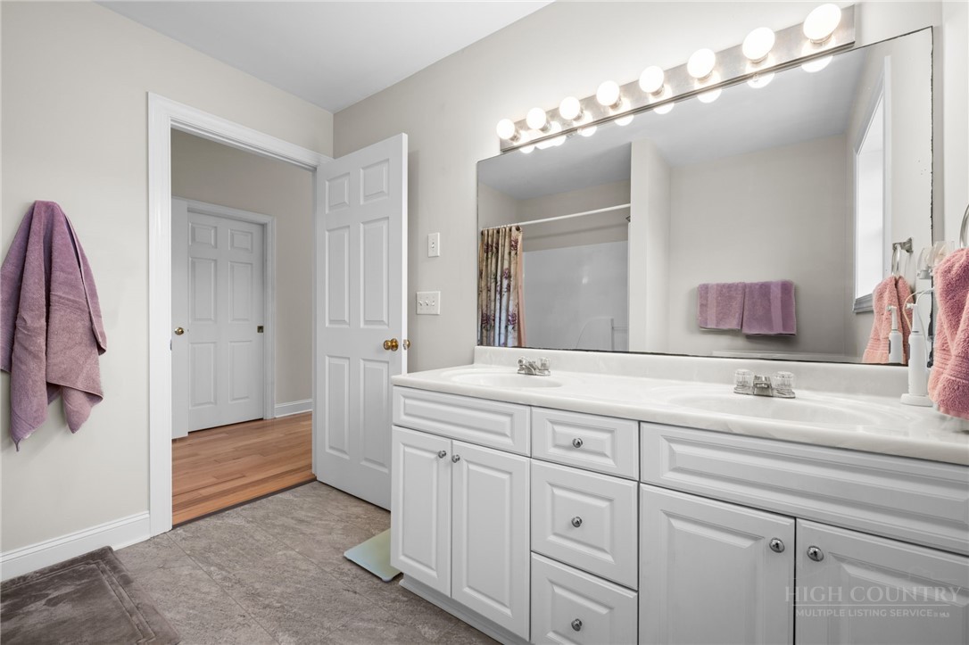 982 Brown's Chapel Road Boone, NC 28607 - Photo 26 of 42 a spacious bathroom with a double vanity sink a mirror and shower