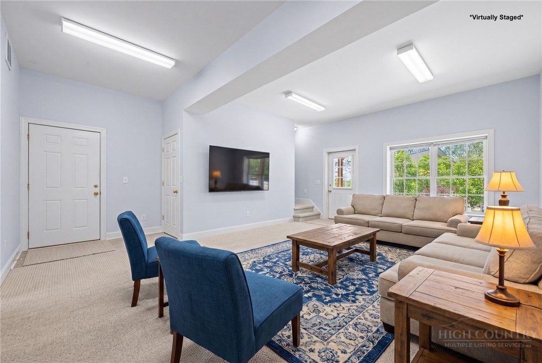 982 Brown's Chapel Road Boone, NC 28607 - Photo 28 of 42 a living room with furniture and a flat screen tv