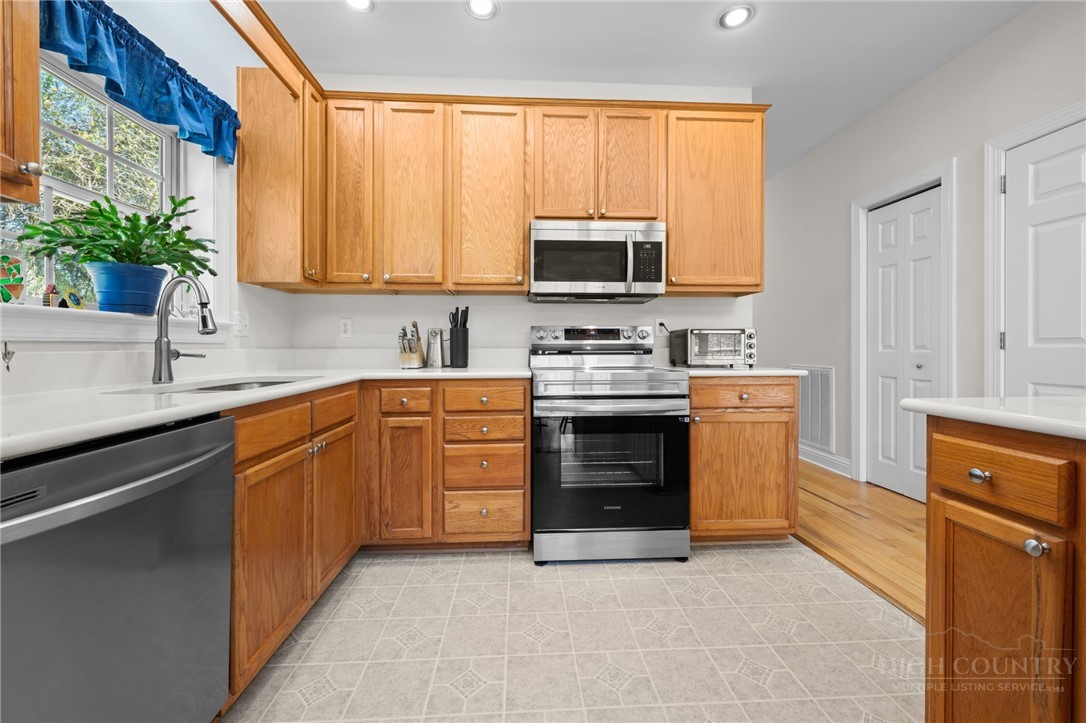 982 Brown's Chapel Road Boone, NC 28607 - Photo 10 of 42 a kitchen with stainless steel appliances a stove sink microwave and cabinets