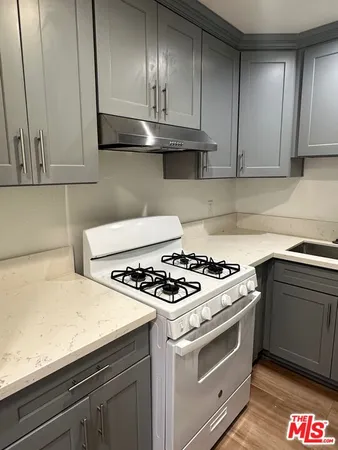 a kitchen with granite countertop stainless steel appliances and wooden cabinets