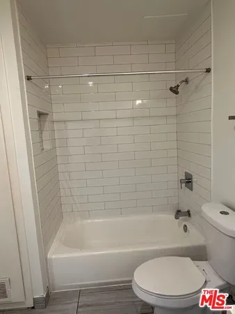 a bathroom with a toilet and a bath tub