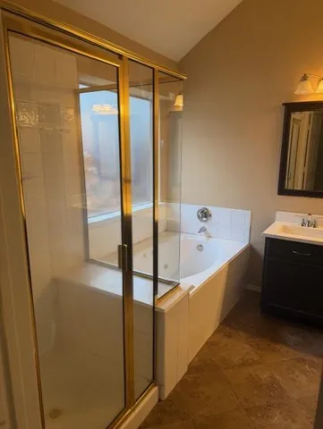 a bathroom with a tub and a shower