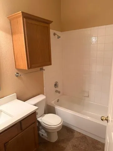a bathroom with a toilet a sink and bathtub