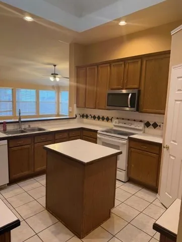 a kitchen with a sink stove and microwave