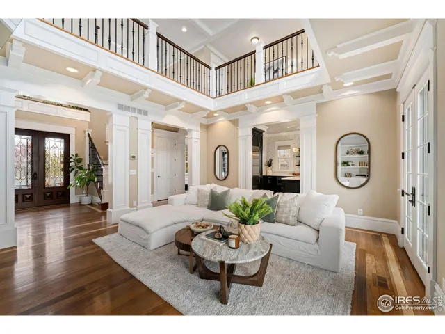 a living room with furniture a clock and a large window