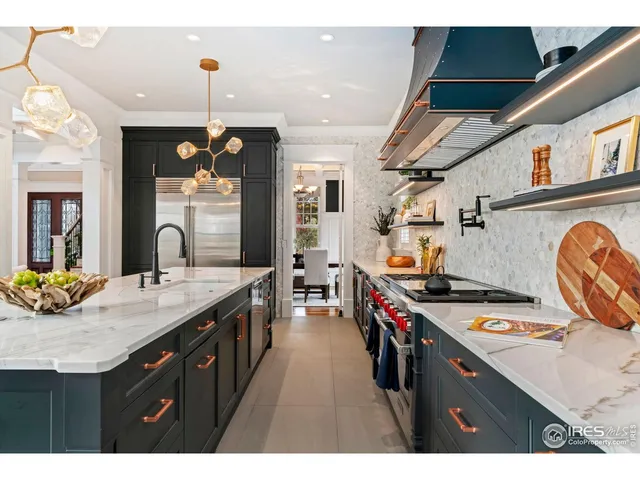 a kitchen with a sink a stove and cabinets