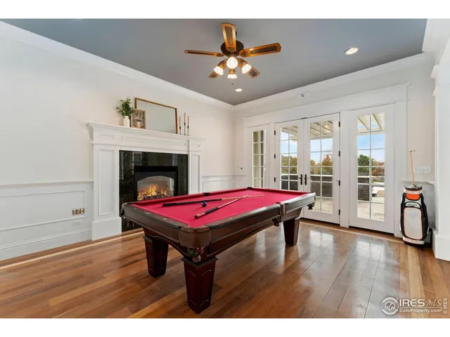 a living room with furniture a table and wooden floor