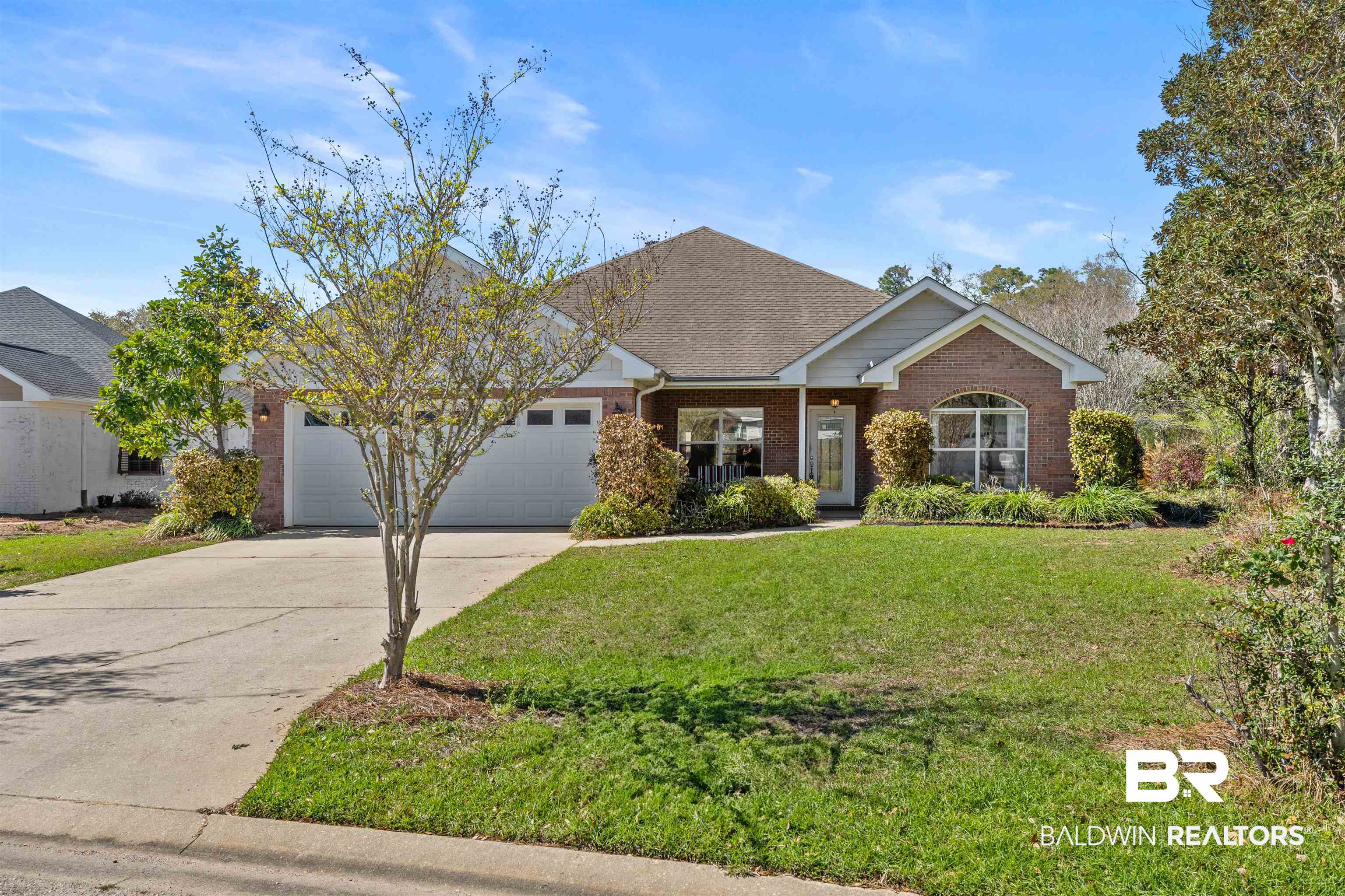 237 Hemingway Loop Foley, AL 36535 - Photo 42 of 49 View of front of house featuring roof with shingles, concrete driveway, an attached garage, a front yard, and brick siding