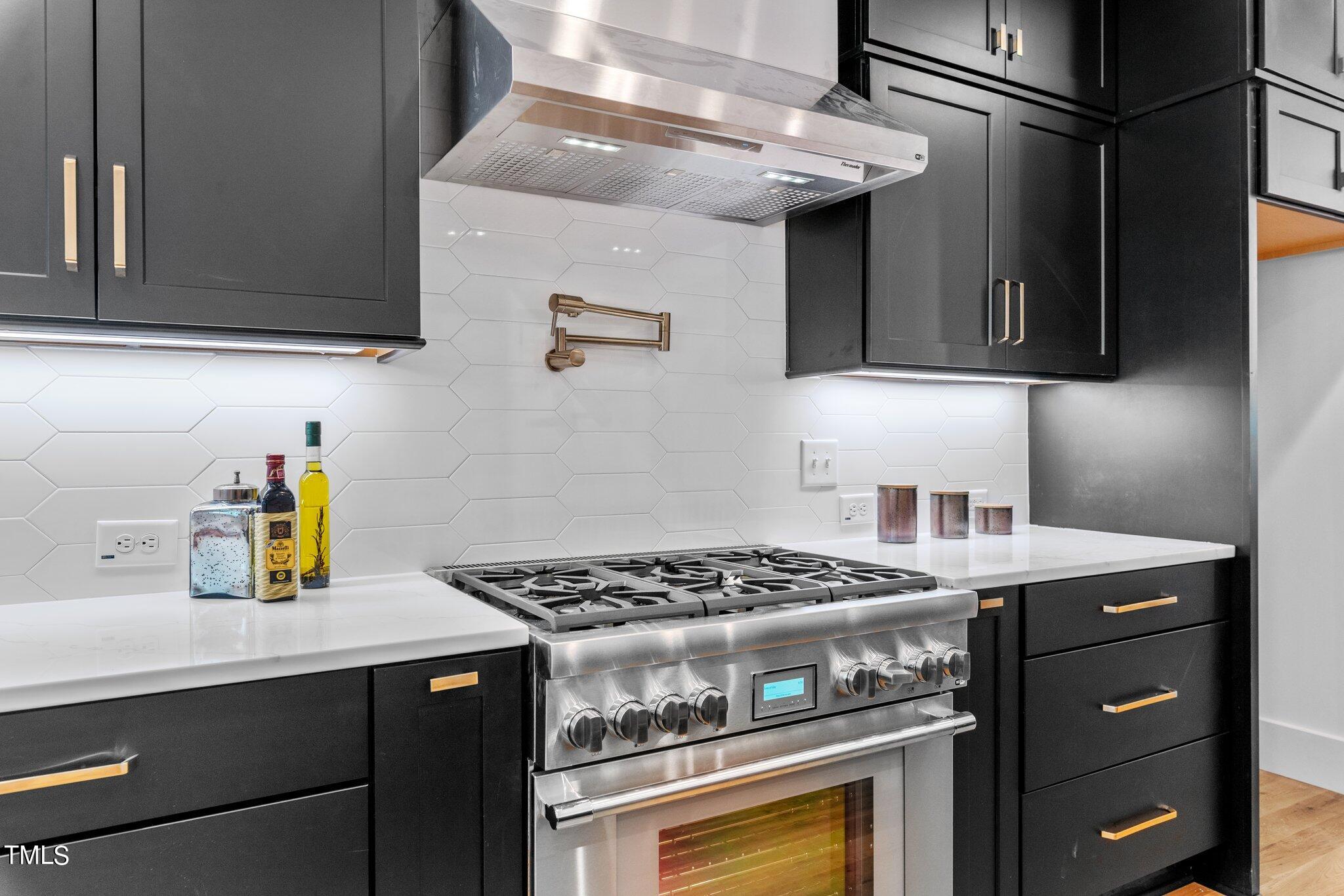1435 Nottingham Road Raleigh, NC 27607 - Photo 11 of 48 a kitchen with stainless steel appliances granite countertop a sink stove and cabinets