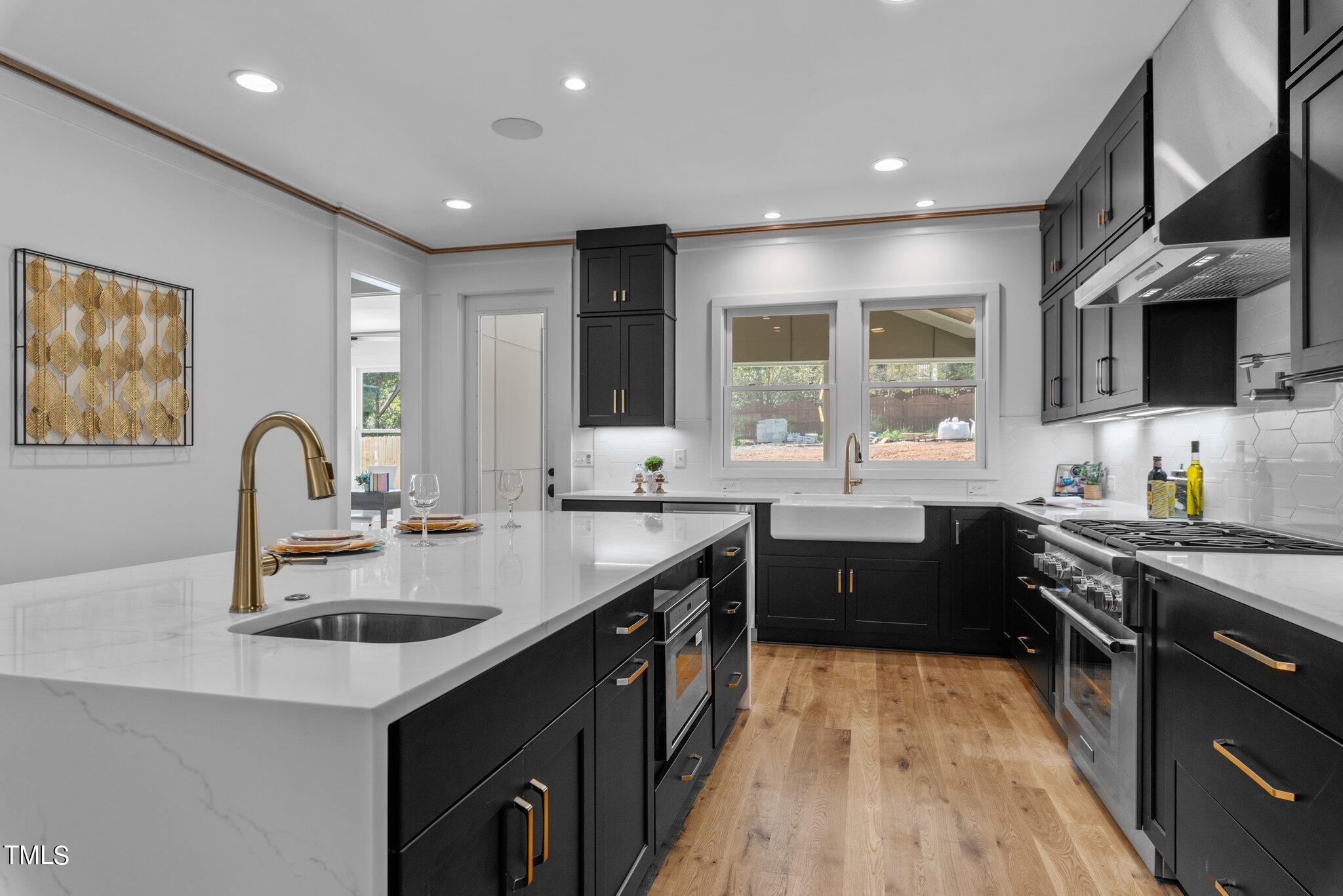 1435 Nottingham Road Raleigh, NC 27607 - Photo 16 of 48 a kitchen with stainless steel appliances granite countertop a sink stove cabinets and wooden floor