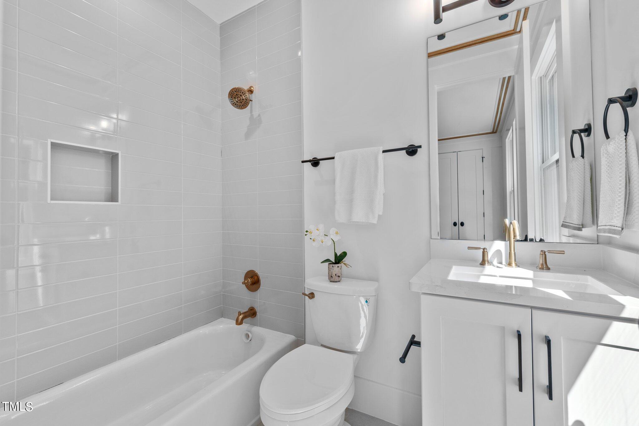 1435 Nottingham Road Raleigh, NC 27607 - Photo 21 of 48 a bathroom with a sink toilet and shower