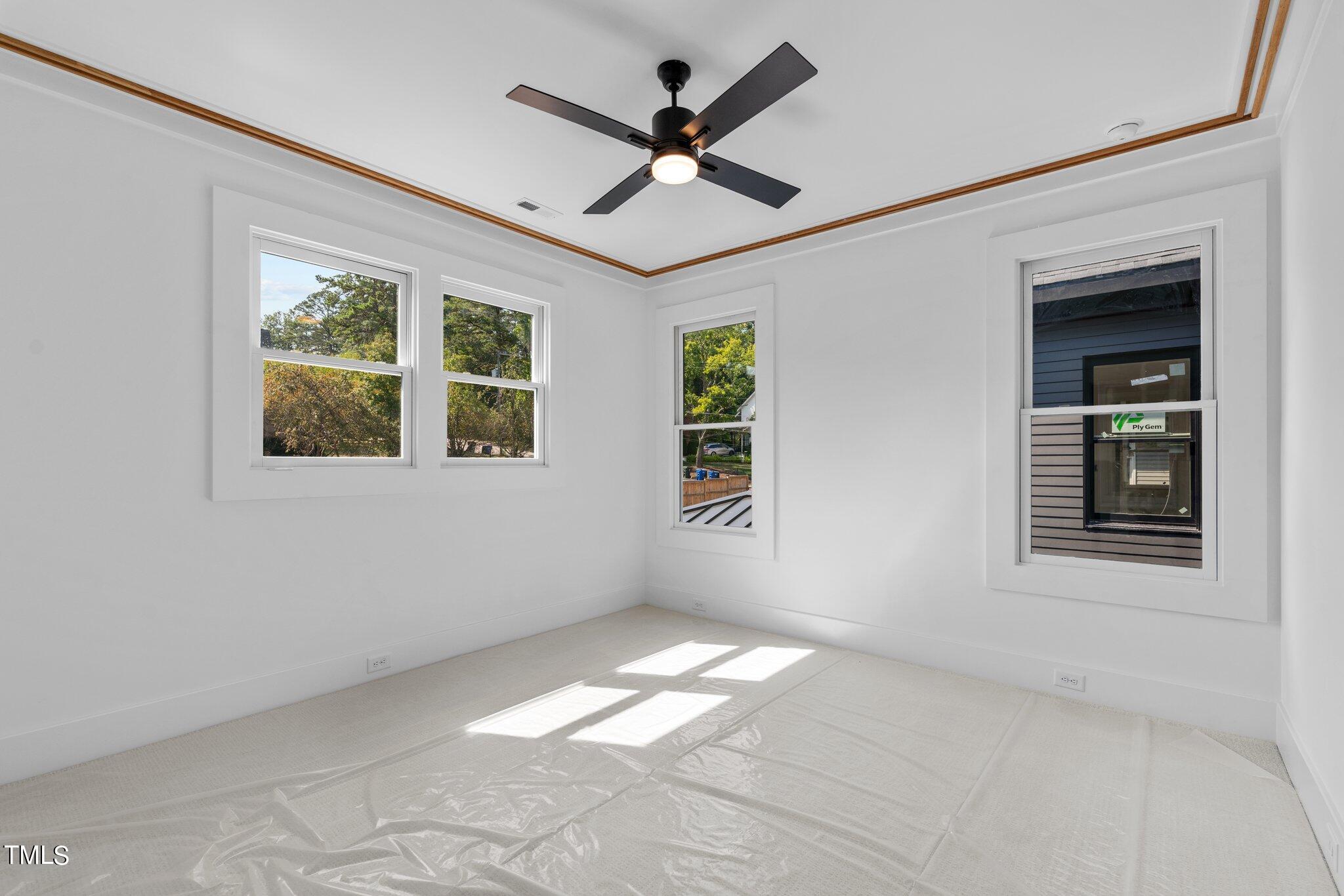 1435 Nottingham Road Raleigh, NC 27607 - Photo 31 of 48 an empty room with windows and ceiling fan