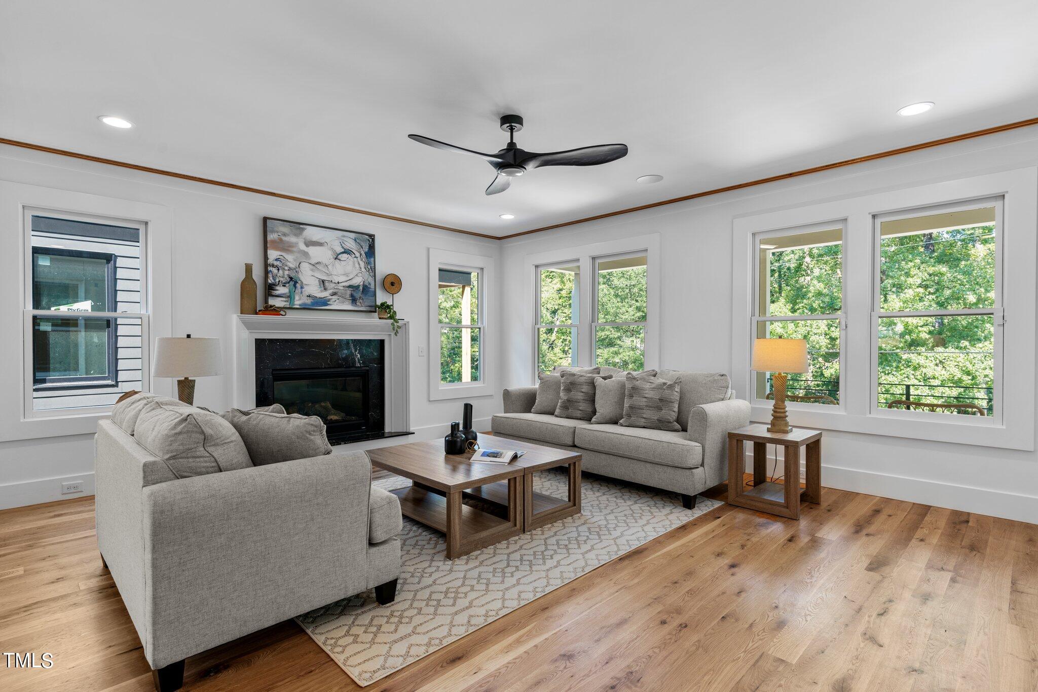 1435 Nottingham Road Raleigh, NC 27607 - Photo 10 of 48 a living room with furniture a fireplace and a large window