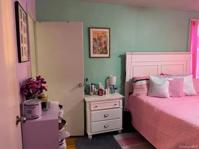 a bedroom with a bed and window