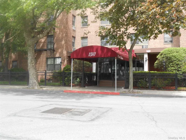 a view of a house with a patio and a yard