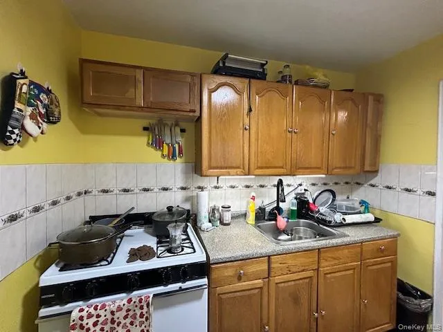 a kitchen with a sink a stove and cabinets
