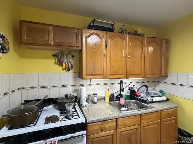 a living room with furniture and baby bed