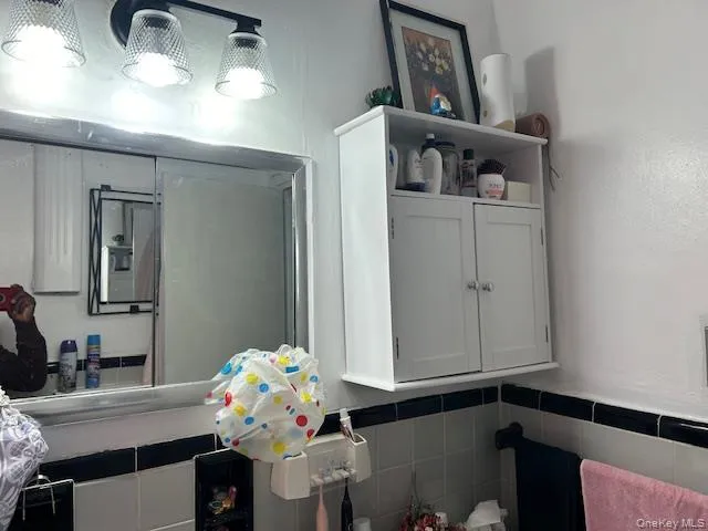 a bathroom with a sink mirror and vanity