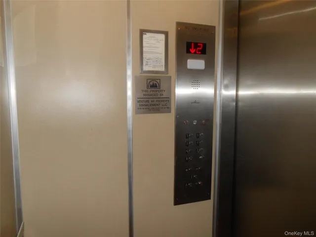 a living room with furniture and a painting on the wall