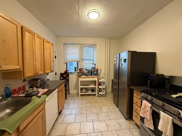 a kitchen with refrigerator and cabinets