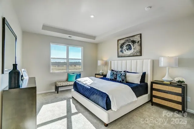 a bedroom with a bed a couch and a window