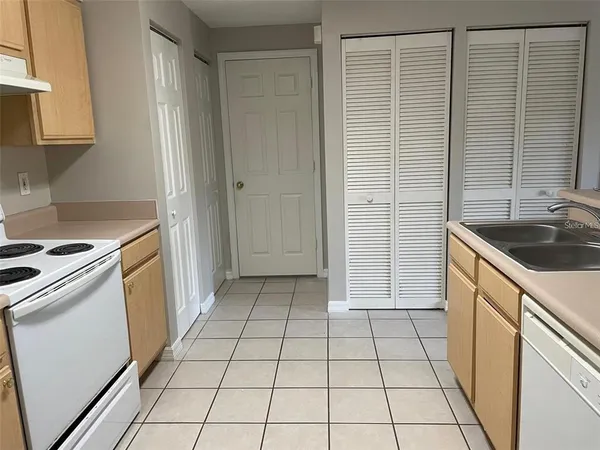 a kitchen with a sink a stove and a refrigerator