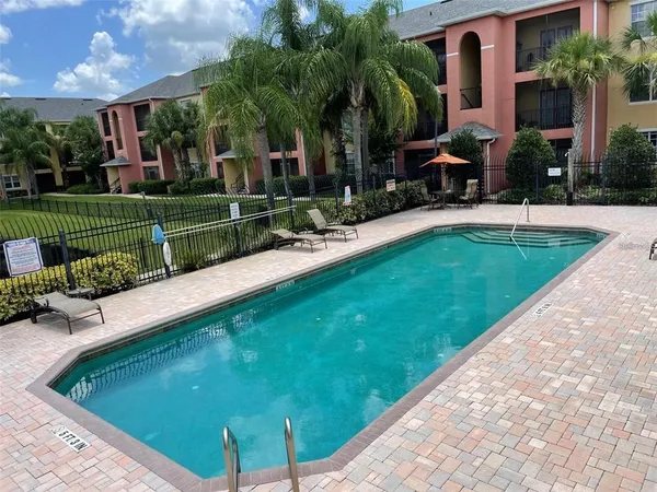 a swimming pool with outdoor seating and yard